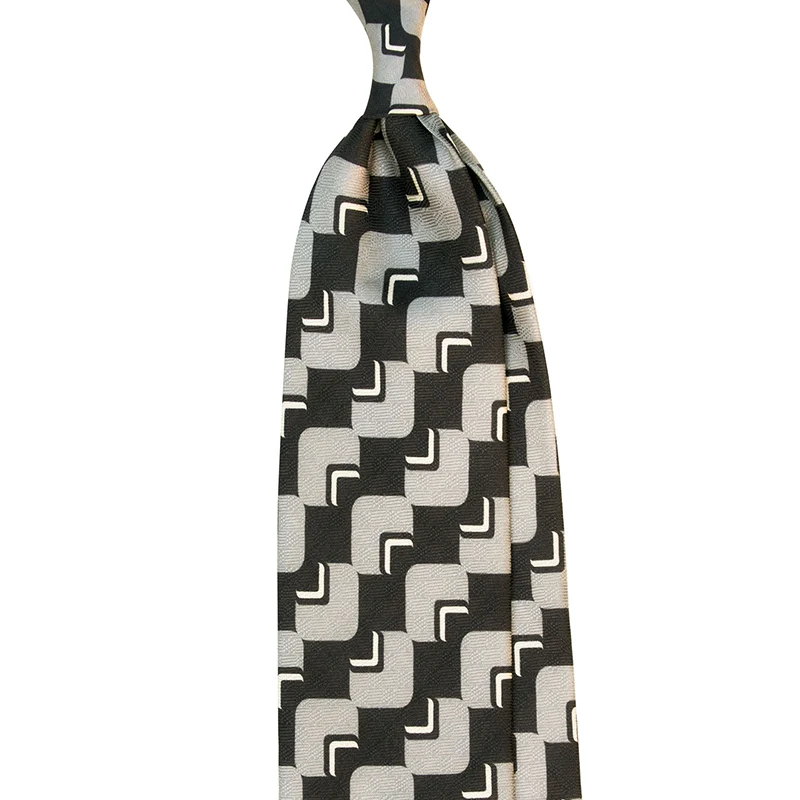 Printed silk jacquard tie with vintage black and grey motifs. Printed and made in Italy by Stefano Cau.
